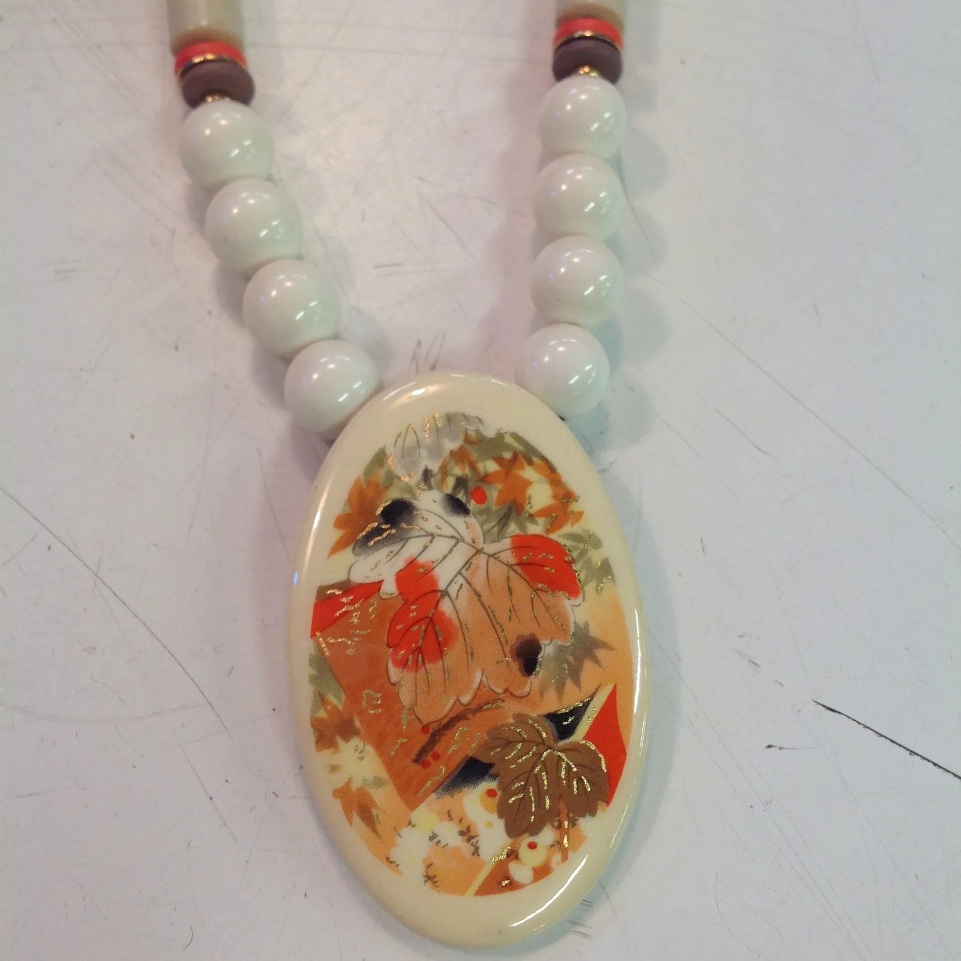 Vintage White Plastic Beaded Necklace with Enamel Autumn Foliage Pendant